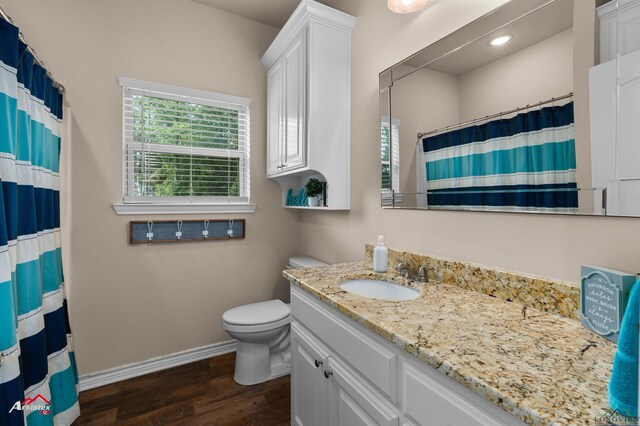 280 Towering Oaks Ln, Longview, TX 75602 - bathroom featuring baseboards, wood finished floors, toilet, vanity, and a shower with curtain