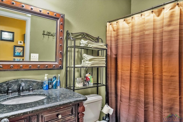 bathroom with toilet and vanity