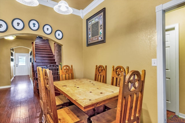 dining area featuring hardwood / wood-style flooring and crown molding