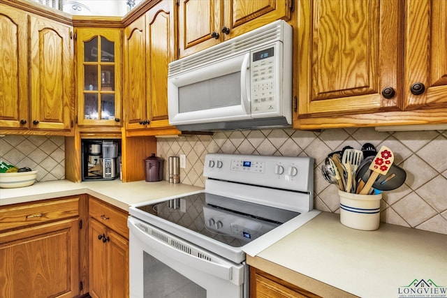 kitchen with white appliances and decorative backsplash