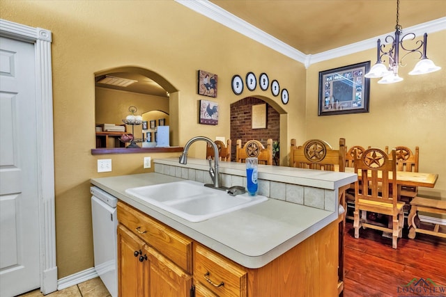 kitchen with sink, a notable chandelier, white dishwasher, hanging light fixtures, and crown molding