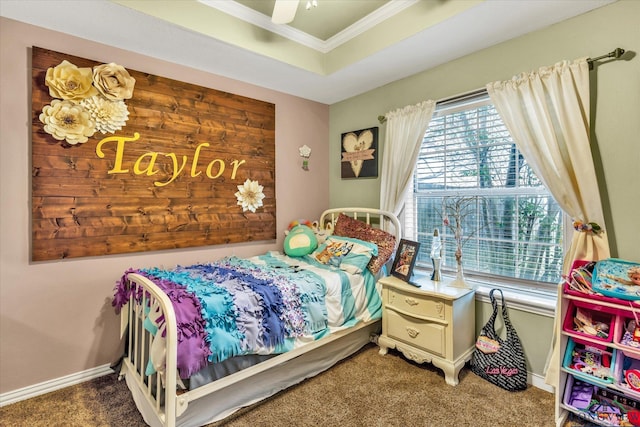 bedroom featuring ornamental molding, carpet floors, ceiling fan, and a tray ceiling