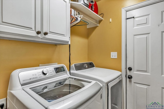 laundry area featuring cabinets and washing machine and clothes dryer