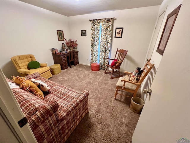 sitting room featuring carpet floors and baseboards