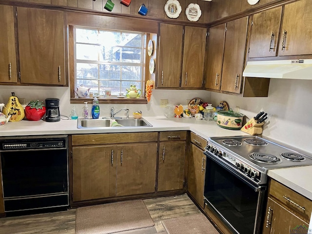 kitchen with under cabinet range hood, a sink, electric stove, light countertops, and dishwasher