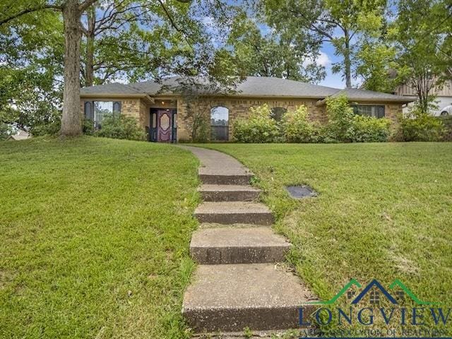 1204 Marigold Ln, Longview, TX 75604 - ranch-style house with a front lawn and brick siding
