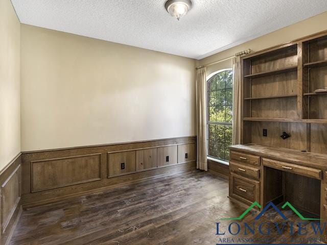 1204 Marigold Ln, Longview, TX 75604 - unfurnished office with a textured ceiling, wainscoting, and dark wood finished floors