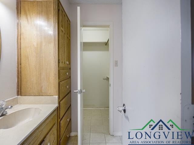 1204 Marigold Ln, Longview, TX 75604 - bathroom with tile patterned flooring and vanity