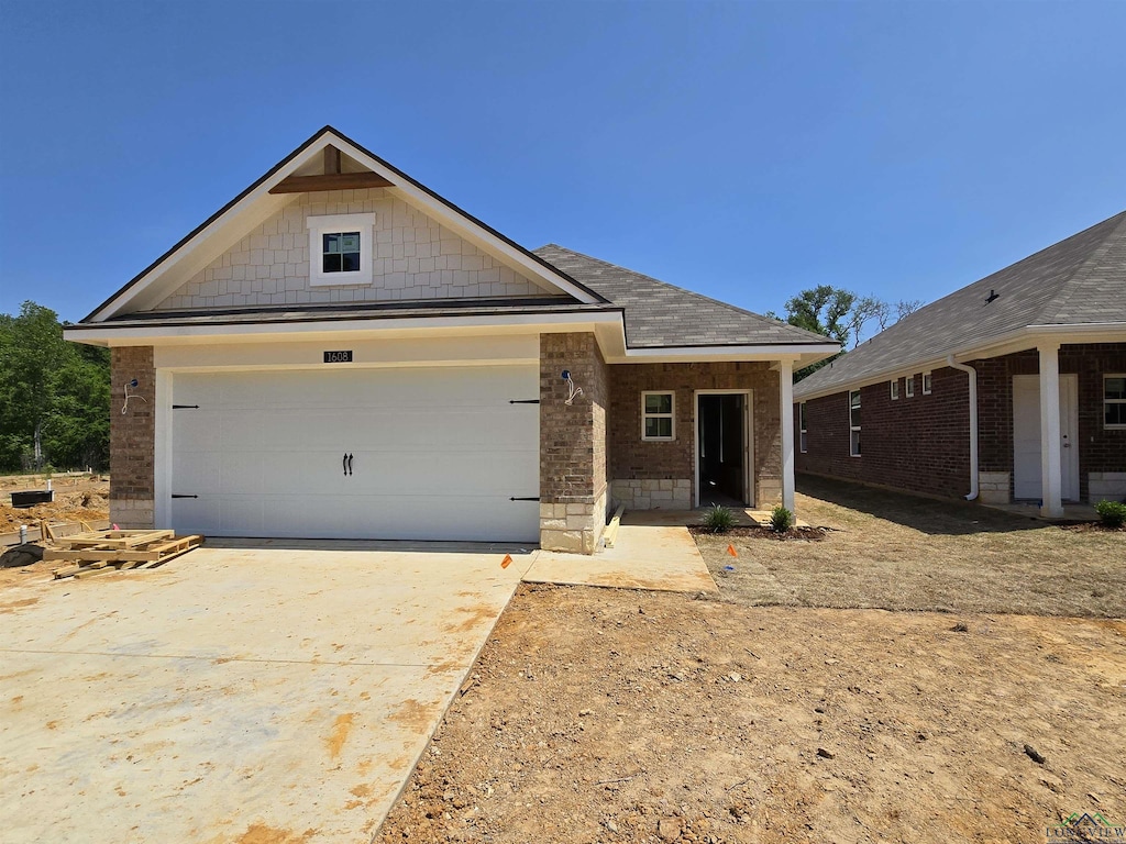 view of front of home with a garage and concrete driveway