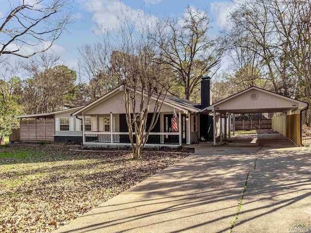 single story home with covered porch and a carport