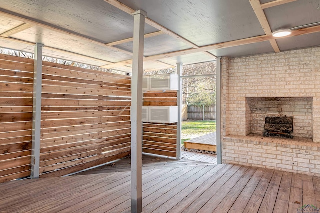 wooden deck featuring an outdoor brick fireplace