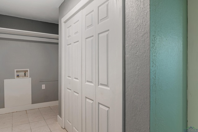 washroom featuring light tile patterned flooring and washer hookup