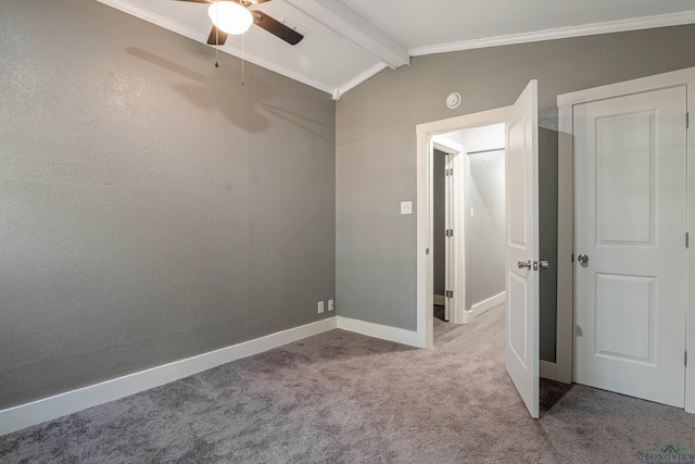 unfurnished bedroom featuring vaulted ceiling with beams, light colored carpet, ceiling fan, and crown molding