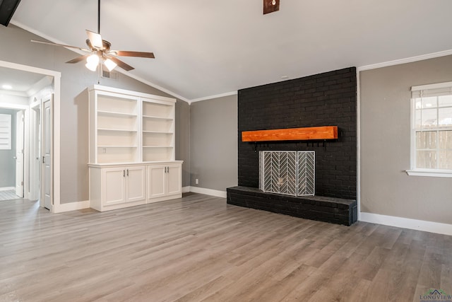 unfurnished living room with light hardwood / wood-style floors, crown molding, lofted ceiling, and a fireplace