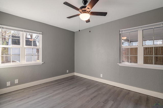 spare room with hardwood / wood-style flooring and ceiling fan