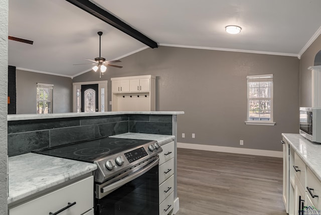 kitchen featuring vaulted ceiling with beams, ornamental molding, appliances with stainless steel finishes, white cabinets, and hardwood / wood-style flooring