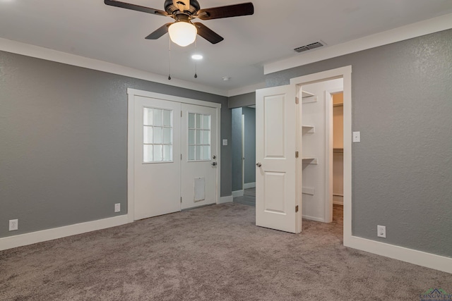 unfurnished bedroom with ceiling fan, light carpet, and a closet