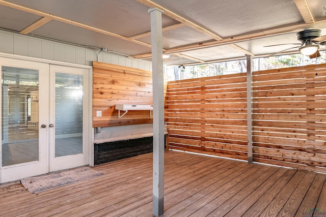 wooden deck with ceiling fan and french doors