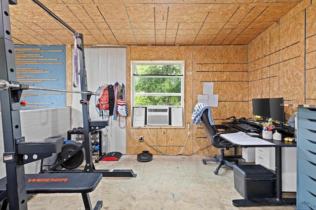 workout area with wood walls and cooling unit