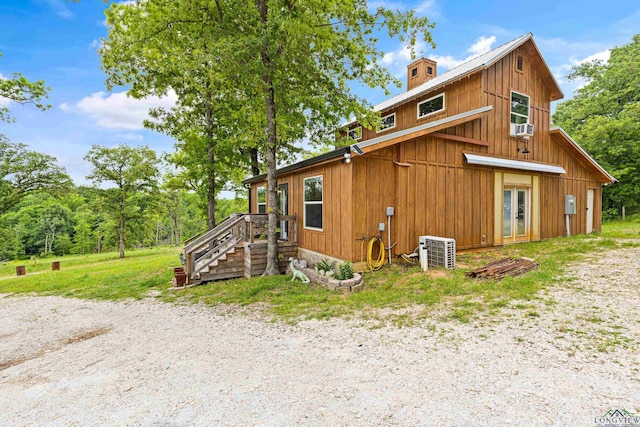 view of property exterior with cooling unit and french doors