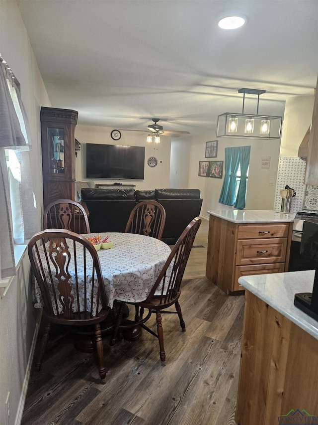 dining area with dark hardwood / wood-style floors, ceiling fan, and plenty of natural light