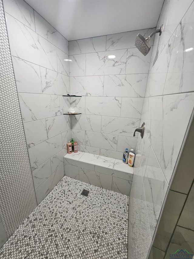 bathroom with tiled shower