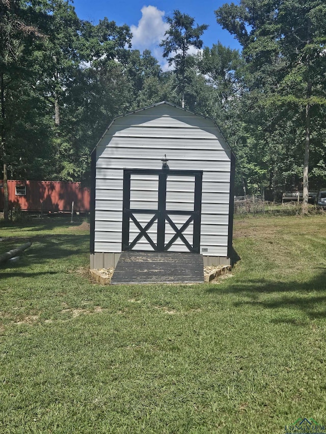 view of outbuilding featuring a yard