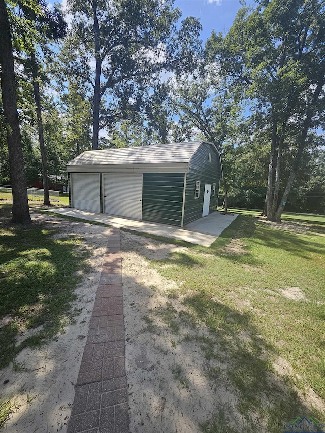 garage featuring a lawn