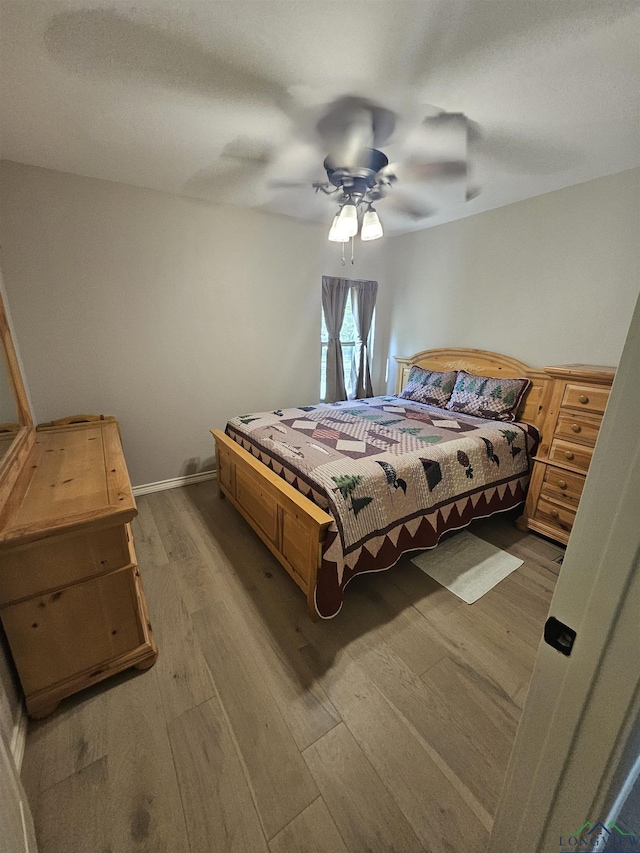 bedroom with ceiling fan and hardwood / wood-style floors