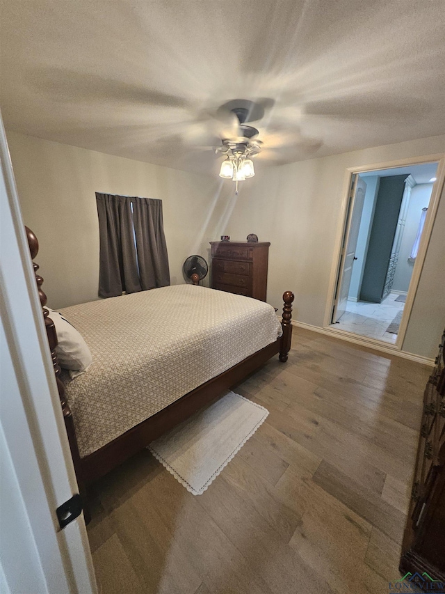 bedroom with ceiling fan and wood-type flooring