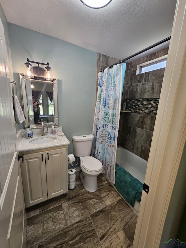 full bathroom featuring a textured ceiling, vanity, toilet, and shower / bathtub combination with curtain