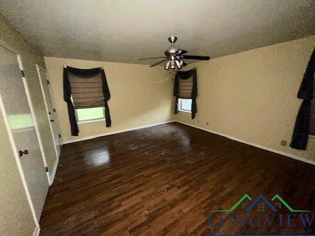 interior space with dark hardwood / wood-style flooring and ceiling fan