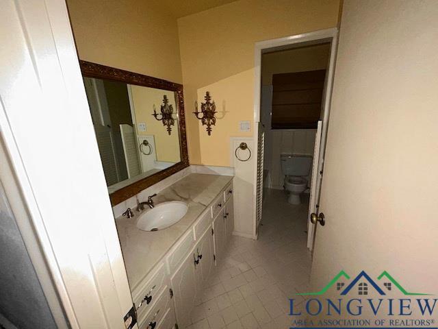 bathroom with tile patterned floors, vanity, and toilet