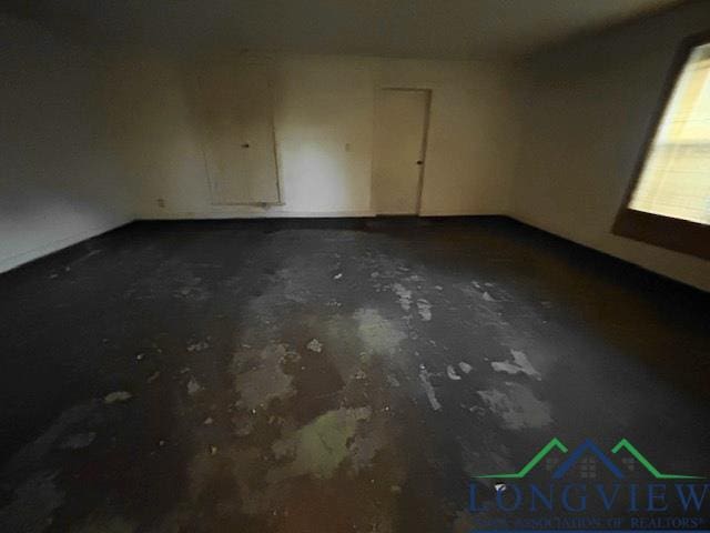 unfurnished room featuring concrete flooring