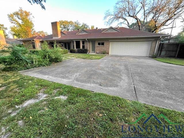 ranch-style home featuring a garage and a front lawn