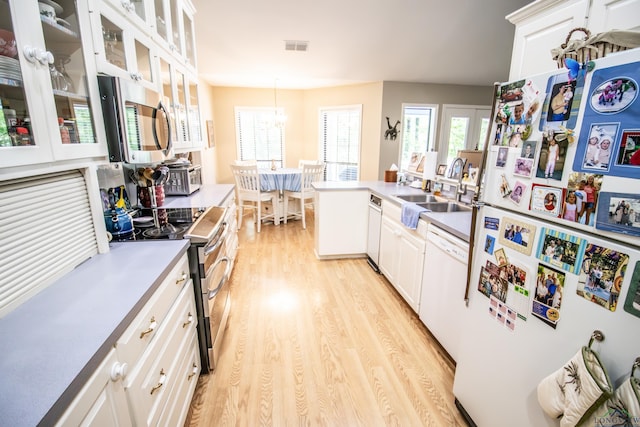 514 Buckeye Hill Rd, Karnack, TX 75661 - kitchen with appliances with stainless steel finishes, a sink, light wood-style flooring, and white cabinetry