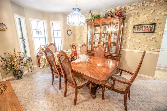 514 Buckeye Hill Rd, Karnack, TX 75661 - dining space featuring a chandelier, light colored carpet, baseboards, and wallpapered walls