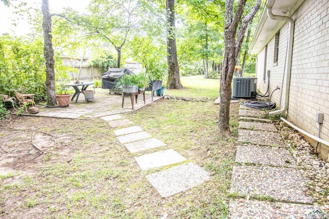 514 Buckeye Hill Rd, Karnack, TX 75661 - view of green lawn with central AC and a patio area