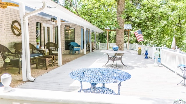 514 Buckeye Hill Rd, Karnack, TX 75661 - view of patio / terrace featuring a ceiling fan, a wooden deck, and outdoor dining area