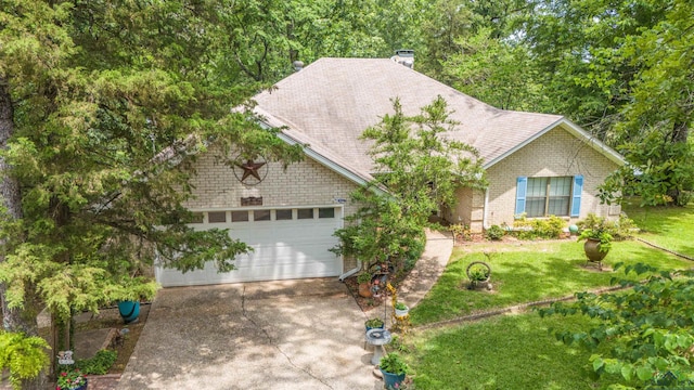 514 Buckeye Hill Rd, Karnack, TX 75661 - view of front of property with driveway, a front lawn, a chimney, a garage, and brick siding
