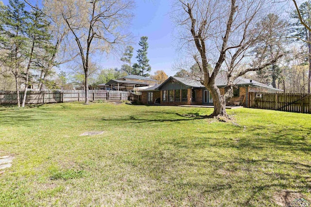 view of yard with a fenced backyard