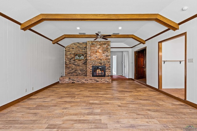 unfurnished living room with visible vents, light wood-style flooring, lofted ceiling with beams, and ceiling fan