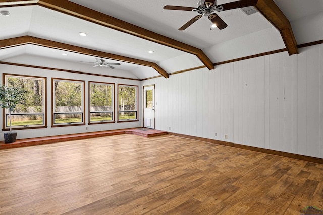 interior space featuring a healthy amount of sunlight, vaulted ceiling with beams, and a ceiling fan