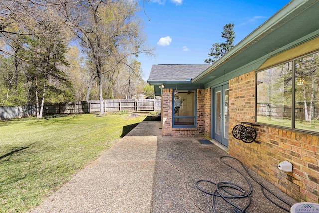 view of yard with a patio area and a fenced backyard