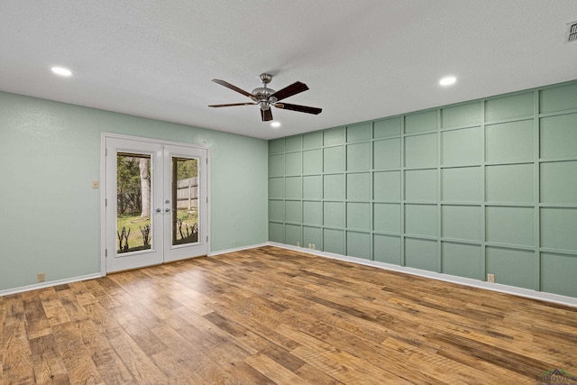 empty room with recessed lighting, french doors, ceiling fan, and wood finished floors