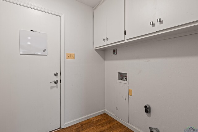 washroom with dark wood-style floors, cabinet space, baseboards, and hookup for a washing machine