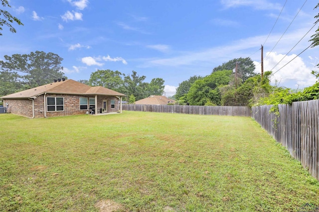 view of yard featuring central air condition unit and a fenced backyard