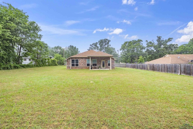 view of yard with a patio area and a fenced backyard