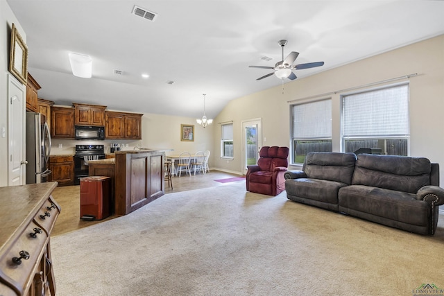 living room featuring vaulted ceiling, visible vents, light colored carpet, and ceiling fan with notable chandelier