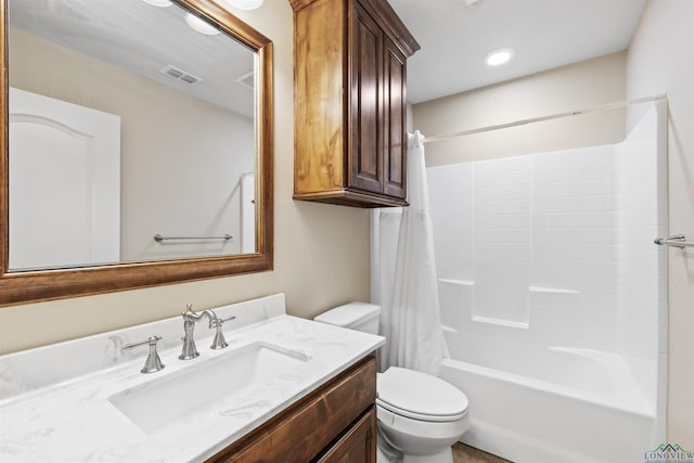 full bath with visible vents, toilet, vanity, and shower / tub combo